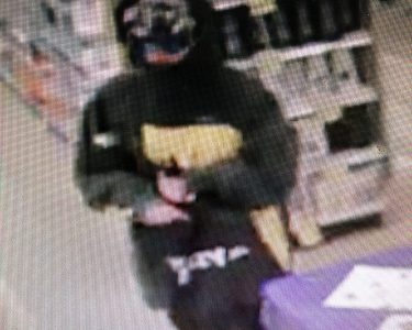 Police release surveillance images after an armed robbery Sunday