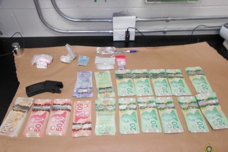 Trail traffic stop leads to seizure of cash, drugs, weapon, two facing charges